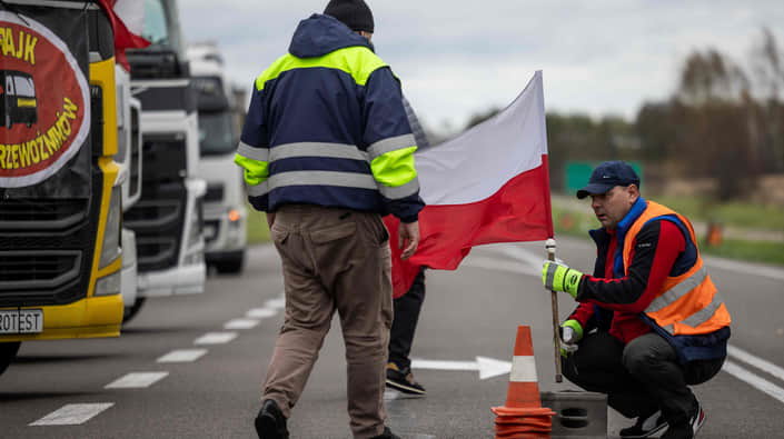 Польські протестувальники з прапором блокують трасу на тлі вантажівок